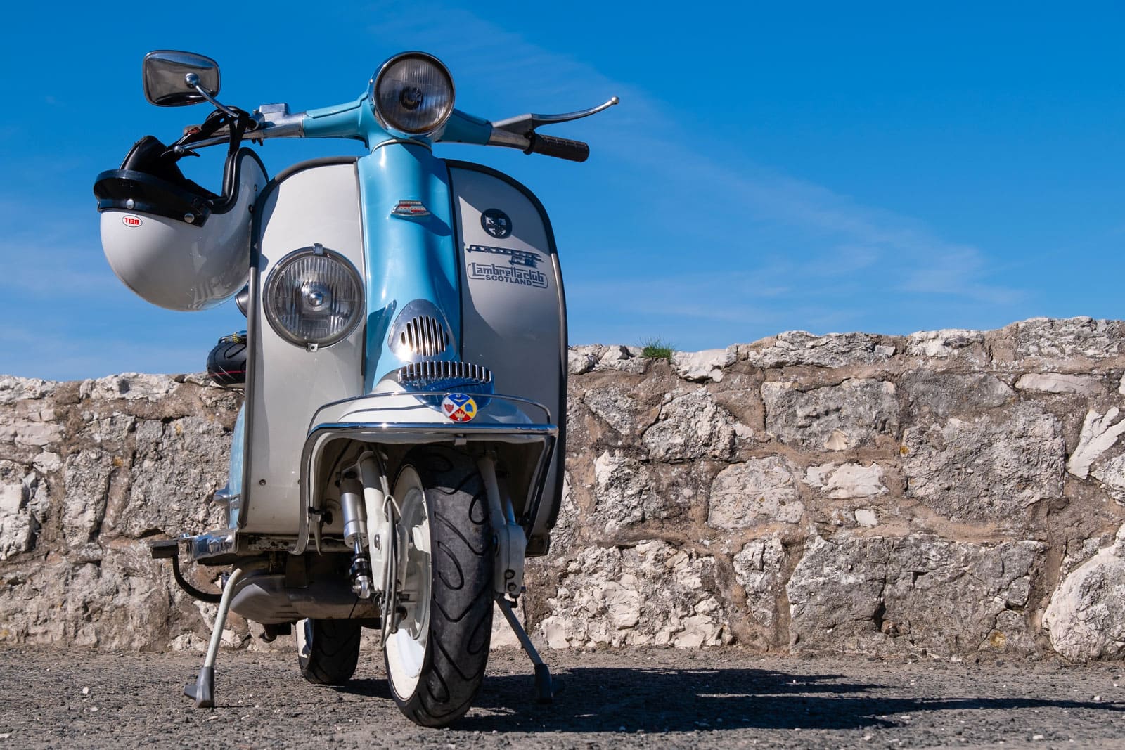 shutterstock 2477727087 ©studio 70sn ballintoy irlande du nord lambretta li 125 scooter italien vintage en bleu pale et blanc avec insigne lambretta club of scotland