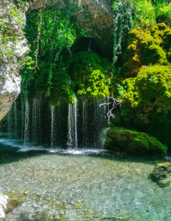 shutterstock 2629095473 ©wirestock creators a vertical image of a beautiful scene of a waterfall with beautiful plants and clear water in fontana capello cilento national park campania italy