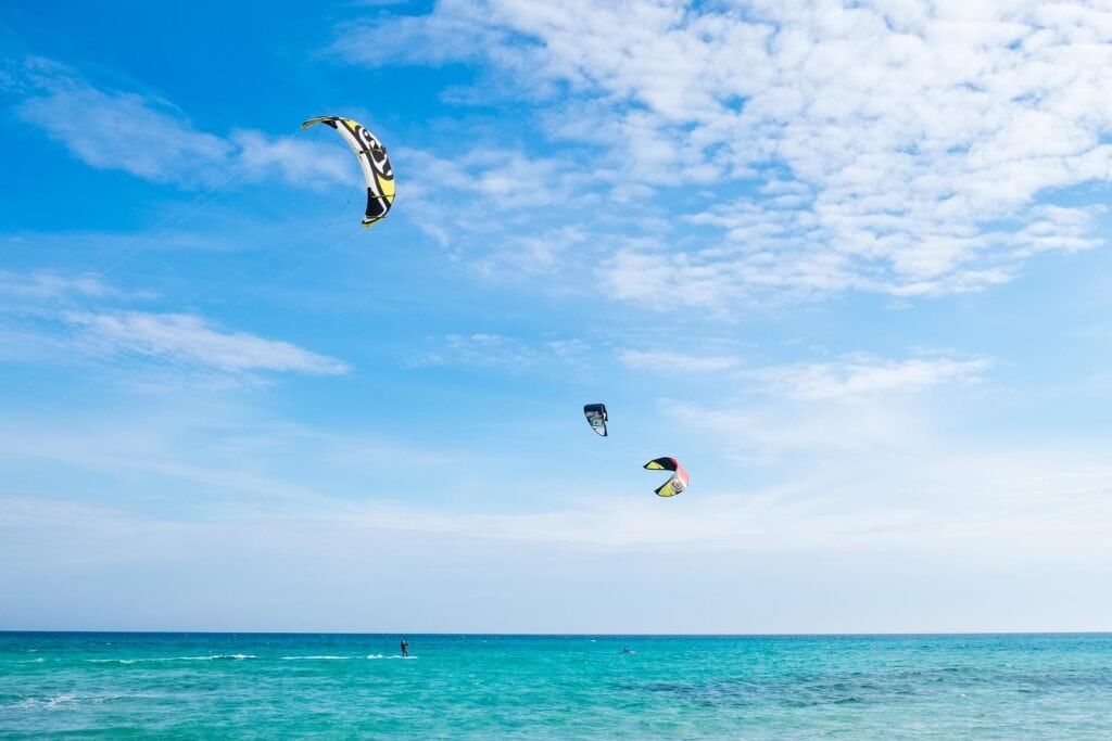 shutterstock 1407985133 photostock360 taranto italy kitesurfers on a sunny day in the ionian sea of southern italy